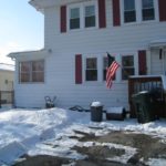 The day I found (and put an offer on) my house. No visible grass, but lovely garbage cans.