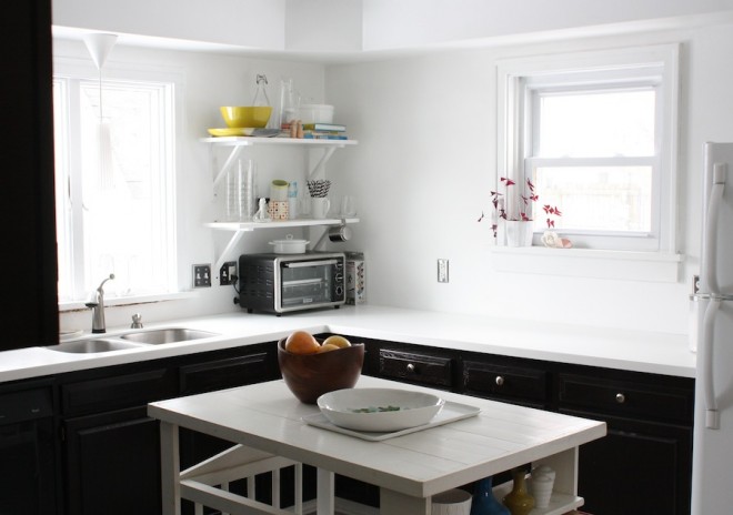 Kitchen transformation progress as of February 2013. Cabinets have been gel stained dark brown, countertops updated with acrylic white.