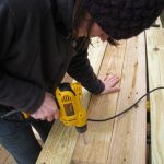Me, drilling holes in the posts for carriage bolts. 