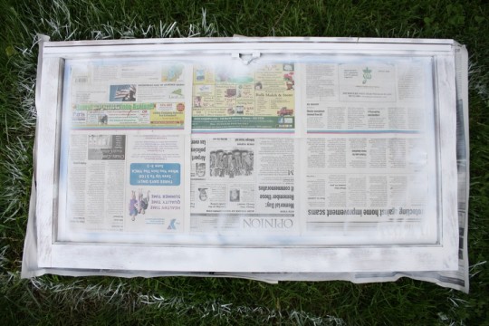 Covered the pane with newspaper and blue painters tape prior to spray priming and painting. Covered the pane with newspaper and blue painters tape prior to spray priming and painting.