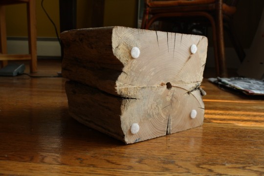 Cushioning the bottom of the lamp base to prevent scratches and level the lamp out.