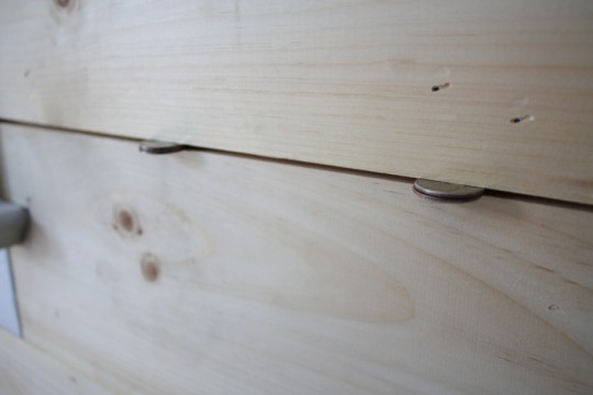Quarter pairs act as spacers as we install each board.