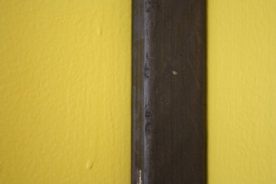 Wee little nail hole. Much better than messing with sloppy, un-stainable wood filler.