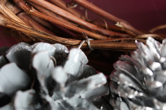 Attaching pine cones individually.