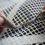 Loop a piece of fabric evenly over the end of the hook.