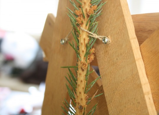 Securing the tree topper to the tree top. Voila.