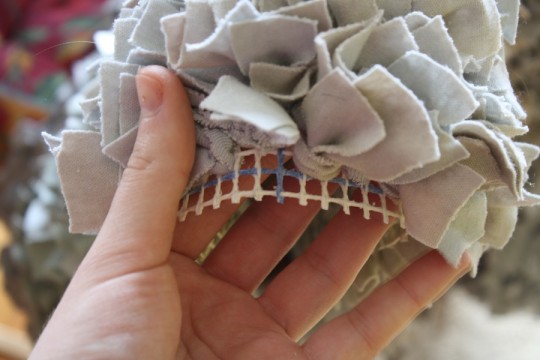 Trimming the excess fabric away from the bear, leaving 1/2" excess for binding.