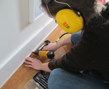Installing baseboard in the office.