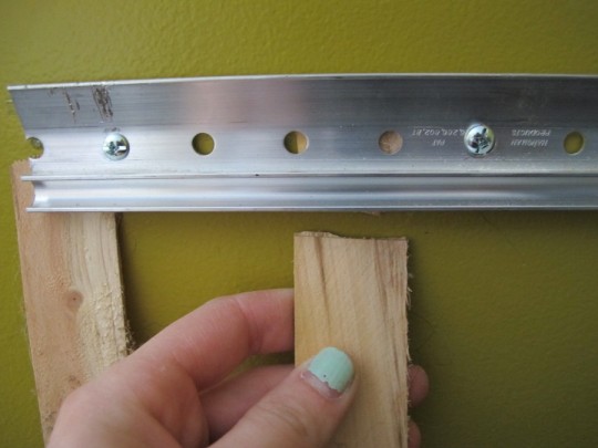 Snapping excess shim from behind the wall-mounted french cleat. Snapping excess shim from behind the wall-mounted french cleat.