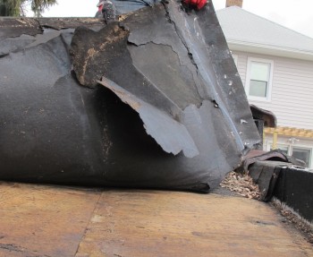 Tar paper damage caused by wind.