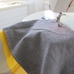 Sewing together two complimentary pieces of fabric to form one of the four pillow seats.