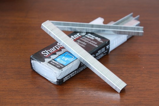 1/4" staples for our electric staple gun: Long enough to reach through the fabric and the wooden underlayment seat, but short enough to not come in contact with our butts when we sit down.