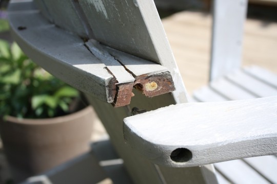 Gorilla Gluing the back brace on an Adirondack chair.