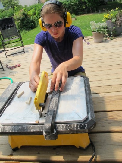 Cutting the tiles on the deck.