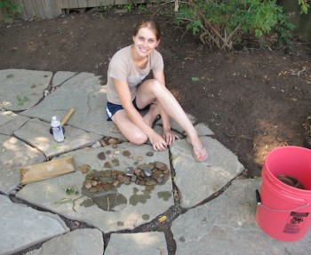 Adding pebbles to our flagstone patio.