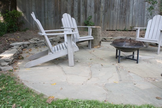 Preventing soil runoff onto our new patio with a small scrap flagstone wall.