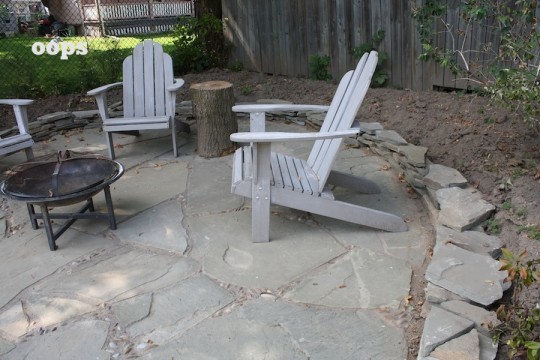 Preventing soil runoff onto our new patio with a small scrap flagstone wall.