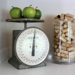 Accent decor in the kitchen: Vintage scale and container of corks.