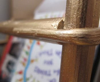 Bentwood magazine rack in gold.