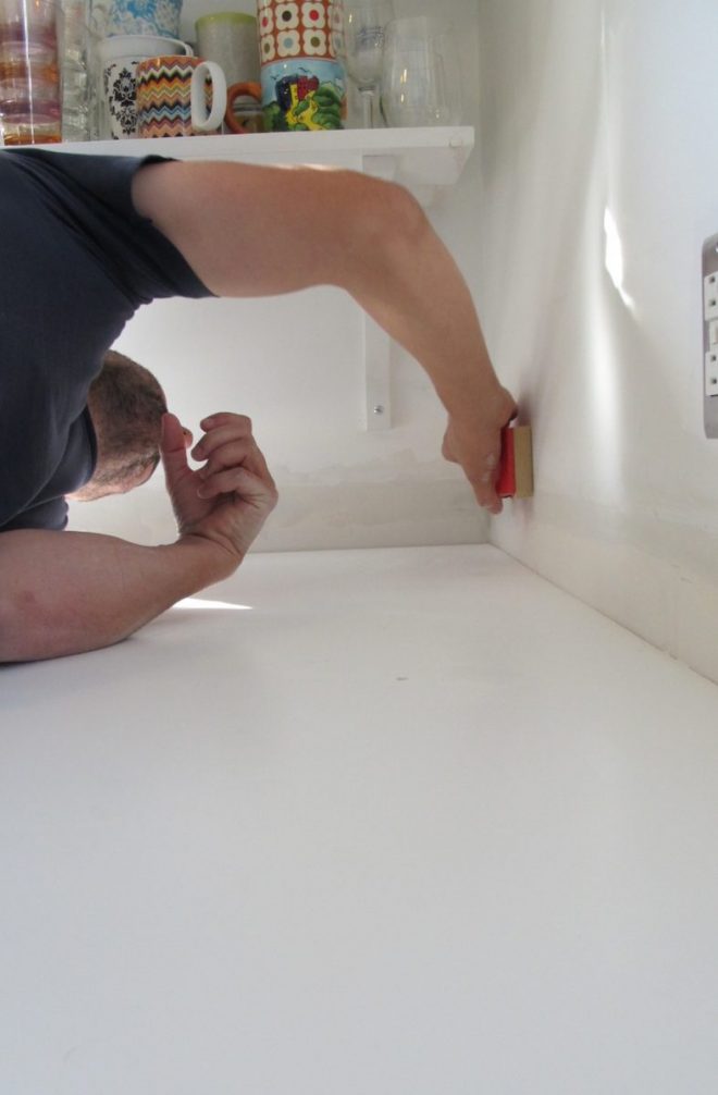 Hand sanding the walls. Hand sanding the walls.
