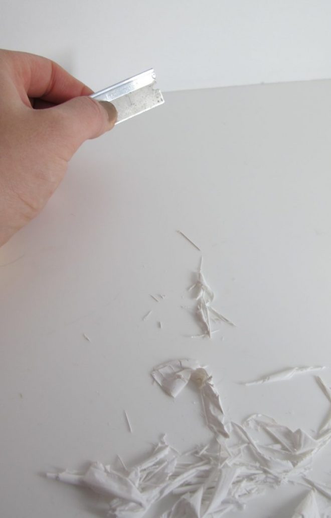 Scraping paint off the countertop edges. Scraping paint off the countertop edges.