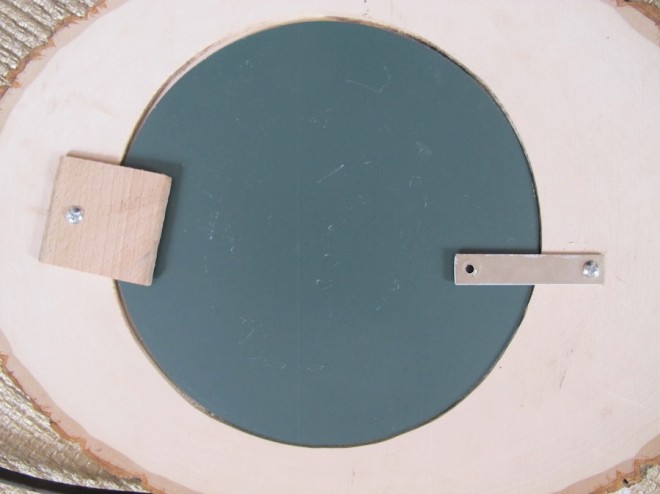 Securing the mirror into place in the frame.