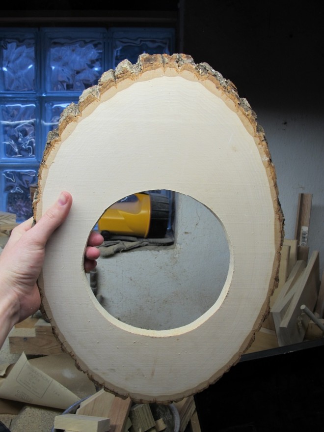 Cut a round hole in the wood panel.