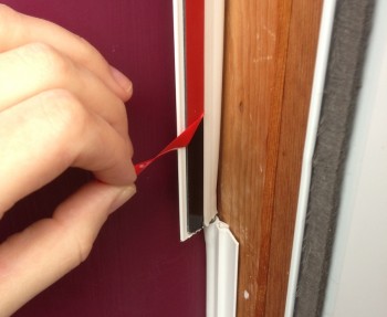 Peel off the adhesive and stick the weatherizer directly to the frame.